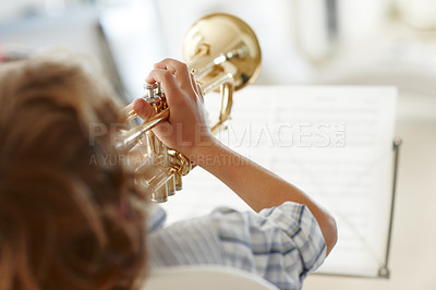 Buy stock photo Rearview shot of a little boy playing the trumpet