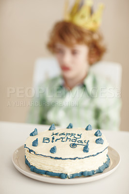 Buy stock photo Birthday party, cake and blur on boy by table in family home for celebration, growth and development. Dessert, decoration and sweet pastry for event, gift and food for child in dining room at house