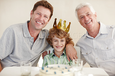 Buy stock photo Father, boy and grandfather in portrait at birthday party for smile, hug or crown for kid in family home. Child, men and generations by cake, happy and bonding with love in dining room for milestone