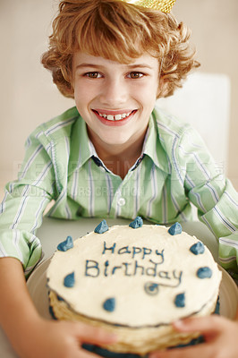 Buy stock photo Birthday cake, boy and happy in portrait at table in family home for celebration, growth and memory. Child, dessert and decoration on sweet pastry for event, smile and milestone with crown in house