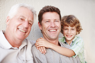 Buy stock photo Hug, portrait and kid with father, grandfather and laughter by a house with care, trust and support. Happy family, bonding and male generations by a wall for weekend, vacation or reunion at home