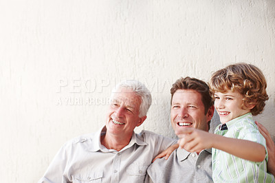 Buy stock photo Cropped shot of a handsome man sitting with his father and his son