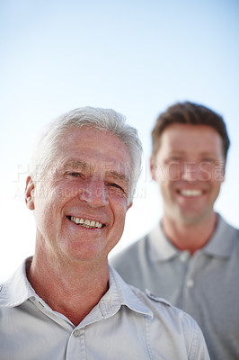 Buy stock photo Cropped portrait of a mature man and his senior father standing outside