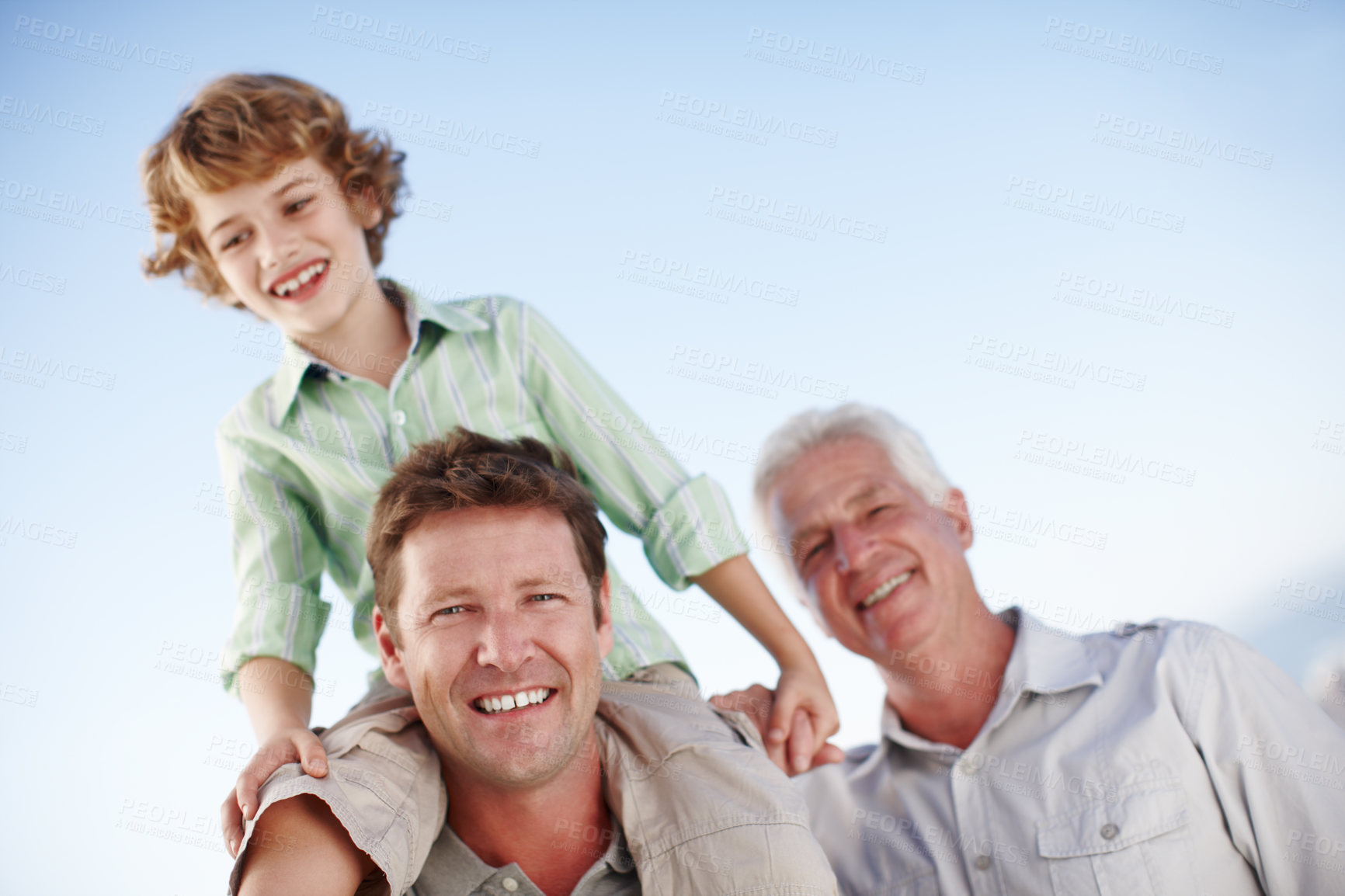 Buy stock photo Portrait of grandfather, father and child by blue sky for bonding, relationship and relax together. Family, generations and grandpa, dad and young boy on shoulders for holiday, vacation and weekend