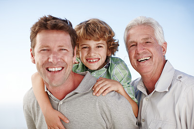 Buy stock photo Portrait of grandfather, dad and child by nature and blue sky for bonding, relationship or relax together. Family, fun and grandpa, father and young boy on shoulders for holiday, vacation and weekend