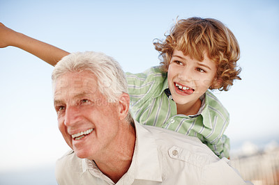 Buy stock photo Happy, park and child on shoulder of grandfather for bonding, relationship and relax together outdoors. Family, nature and grandpa with young boy on summer holiday, vacation and weekend with blue sky