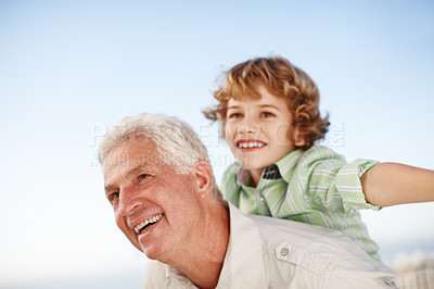 Buy stock photo Happy, piggy back and child with grandfather in park for bonding, relationship and relax together outdoors. Family, nature and grandpa with excited young boy on summer holiday, vacation and weekend