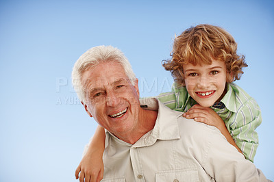 Buy stock photo Happy, blue sky and portrait of grandfather and child piggy back for bonding, relationship and relax outdoors. Family, nature and grandpa with young boy on summer holiday, vacation or weekend at park