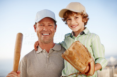 Buy stock photo Cropped portrait of a mature man carrying his young son while out playing baseball