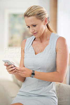 Buy stock photo Cropped shot of an attractive businesswoman sending a text