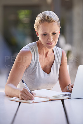 Buy stock photo Cropped shot of an attractive businesswoman working on her laptop
