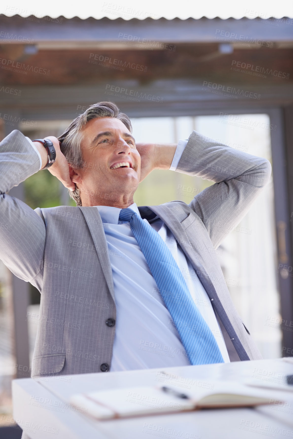 Buy stock photo Businessman, happy and relax with stretching in office for work break, mental health and finish goal target. Worker, smile and arms behind head for calm rest with achievement, productivity and pride