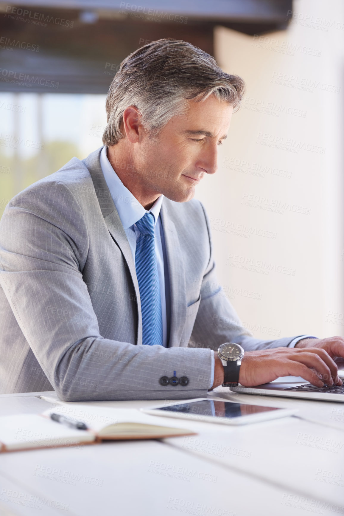 Buy stock photo Cropped shot of a handsome businessman in the office