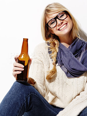 Buy stock photo Happy woman, portrait smile and relax with beer of nerd, geek or hipster against a studio background. Attractive female person or model with glasses, nerdy or fashion style holding bottle of alcohol