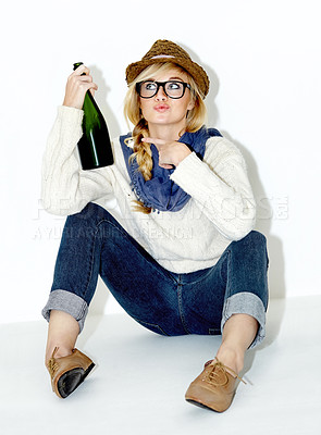 Buy stock photo Champagne, drunk or relax with woman on floor in studio with hangover celebration, party or event. Pointing or female person drinking alcohol or beverage in bottle for New Year on white background