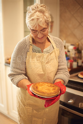 Buy stock photo Senior woman, proud and happy with pie in kitchen, house and home with smile, dinner and food. Elderly lady, female person and looking at pastry dessert for retirement, cooking and enjoyment
