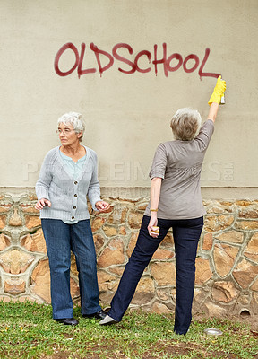 Buy stock photo Wall, spray paint and graffiti by senior women for illegal activity, vandalism or street art. Elderly people or friends with glove for retirement leisure and fun at nursing home in Amsterdam