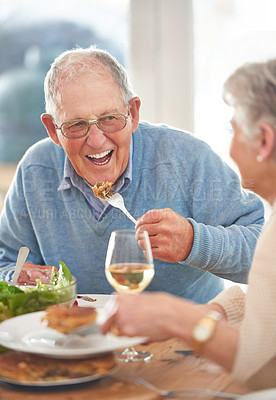 Buy stock photo Happy, love and elderly couple eating lunch together in the dining room of their modern home. Happiness, smile and senior man and woman in retirement talking, bonding and enjoying meal in their house