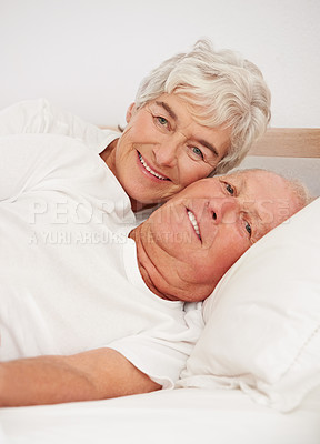 Buy stock photo Senior couple, portrait and together in bed, relaxing and love in retirement for bonding on weekend. Elderly people, bedroom and resting or happy in marriage, romance and morning routine at home
