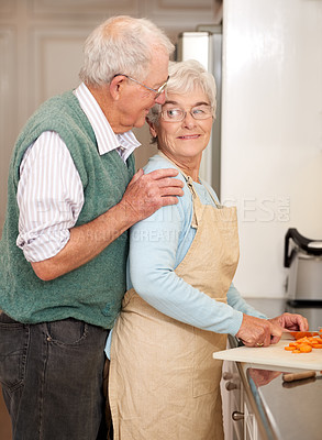 Buy stock photo Senior couple, cutting vegetables and bonding in kitchen, food preparation and love at home. Elderly people, healthy meal and organic ingredients or carrots for nutrition, conversation and retirement