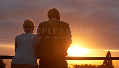 Buy stock photo Cropped shot of an elderly couple sharing a romantic moment at sunset