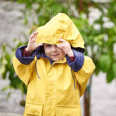 Buy stock photo Winter, rain and portrait of boy with jacket for cold, vacation and happiness with enjoyment in Australia. Little kid, face and smile in nature for weekend, adventure or holiday in gloomy weather
