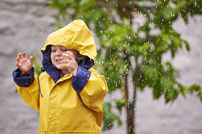 Buy stock photo Boy, jacket and rain with smile in winter for playful, carefree childhood and freedom in Australia. Happy, little kid and water in nature for holiday, vacation or travel on weekend in cold weather