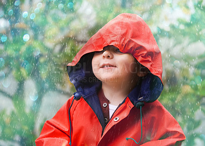 Buy stock photo Child, rain and raincoat in style for fashion, jacket or cold weather in winter. Little boy, male toddler and kid in drizzle by tree, bokeh or environment with windbreaker for chilly season in London
