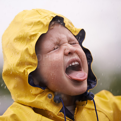 Buy stock photo Child, nature and rain with jacket for freedom, fun and carefree enjoyment in Australia. Droplets, kid and face with tongue out for vacation, weekend or holiday in winter with water protection