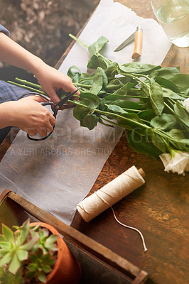 Buy stock photo Cropped shot of a florist cutting flowers to make up a bouquet