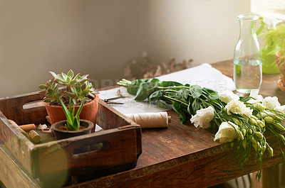 Buy stock photo Shot of a bunch of flowers and other plants lying on a florist's worktable
