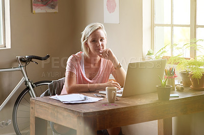 Buy stock photo Portrait of a female freelancer working on her laptop at home