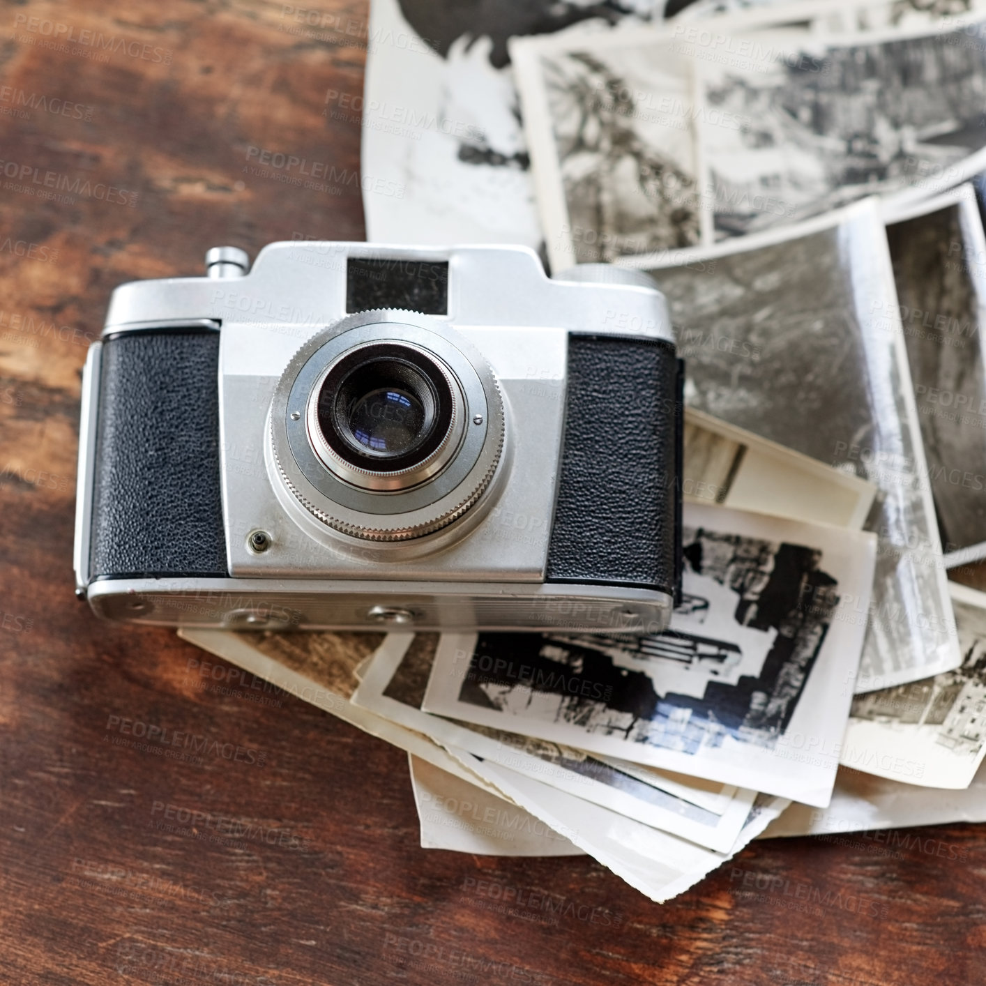 Buy stock photo Wooden desk, vintage and camera with vintage photographs on black and white. Digital, old school and table with images for creativity, project and collection for filming, photoshoot and artistic