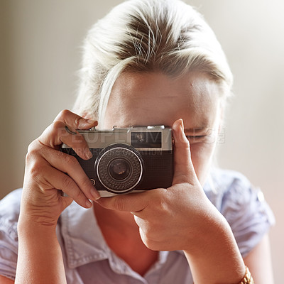 Buy stock photo Closeup shot of a young woman taking a photograph with an old-fashioned camera