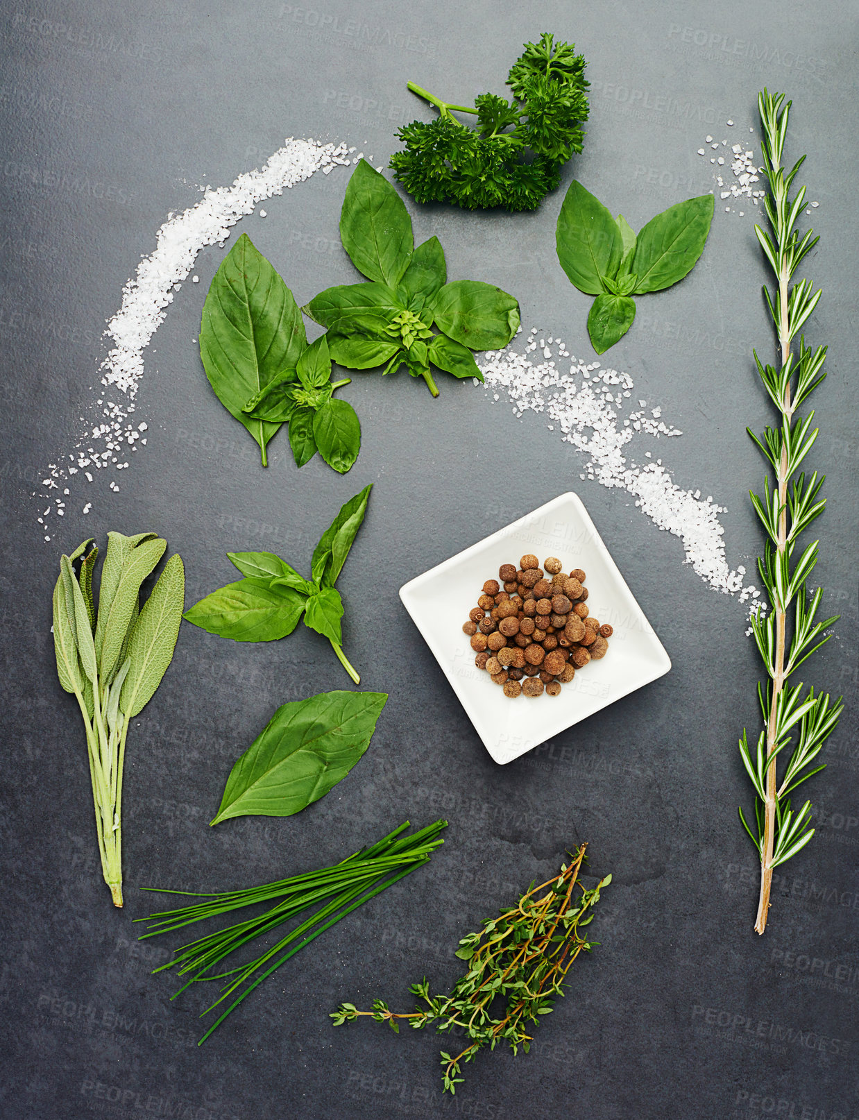 Buy stock photo Cooking, herbs and salt isolated on black background for health, wellness and nutrition. Seasoning, greens and above view of bowl on dark surface in kitchen with food plant and leaves in studio.