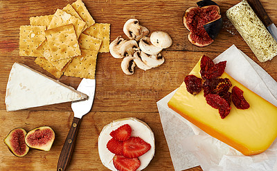 Buy stock photo Fruit, cheese and knife on kitchen table for food with appetizer, healthy eating and gourmet snack. Charcuterie board, wellness and strawberry on wood surface with brunch, mushrooms and fine dining