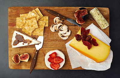 Buy stock photo Fruit, cheese and knife on cutting board for food with gourmet snack, healthy eating and appetizer. Charcuterie platter, wellness and mushrooms on wood surface with brunch, strawberry and fine dining