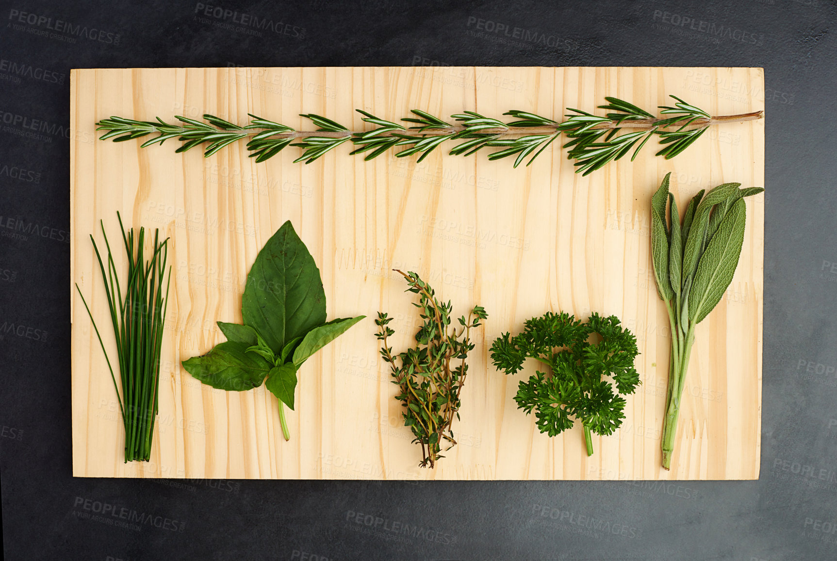 Buy stock photo Parsley, thyme, and rosemary on chopping block for nutrition, health and adding flavour to food. Green herbs, basil and vegetables on kitchen cutting board for cooking, eating and vegan diet