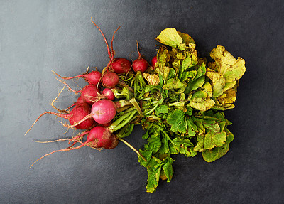 Buy stock photo Radish, organic and roots on dark background for nutrition, health and weight loss. Vegetables, diet and market produce isolated in studio for vegan, food and cooking in house from natural resource.