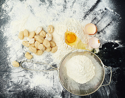 Buy stock photo Eggs, flour and pasta for cooking in kitchen with Italian cuisine, dough recipe and dinner ingredients. Gnocchi, table top and carbs on dark background for healthy eating, yellow color and lunch food