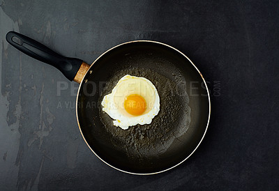 Buy stock photo Egg, frying or cooking on pan for healthy breakfast, lunch or dinner  in studio with top view and black background. Preparing, meal and seasoning for chef, cook or restaurant serving balanced diet