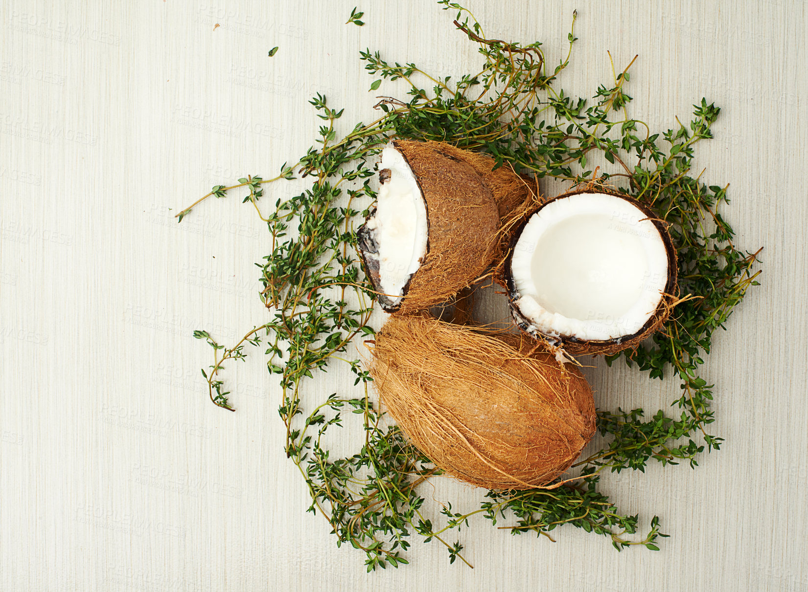 Buy stock photo Fresh, coconuts and thyme for healthy nutrition, balanced diet and plant based protein in studio background. Organic, herbs and tropical fruit for wellness, weight loss or vegan cuisine and eating 