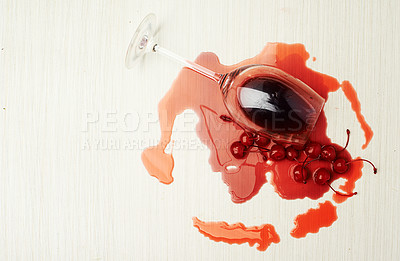 Buy stock photo Studio shot of a wine glass with cherries and wine spilling out of it