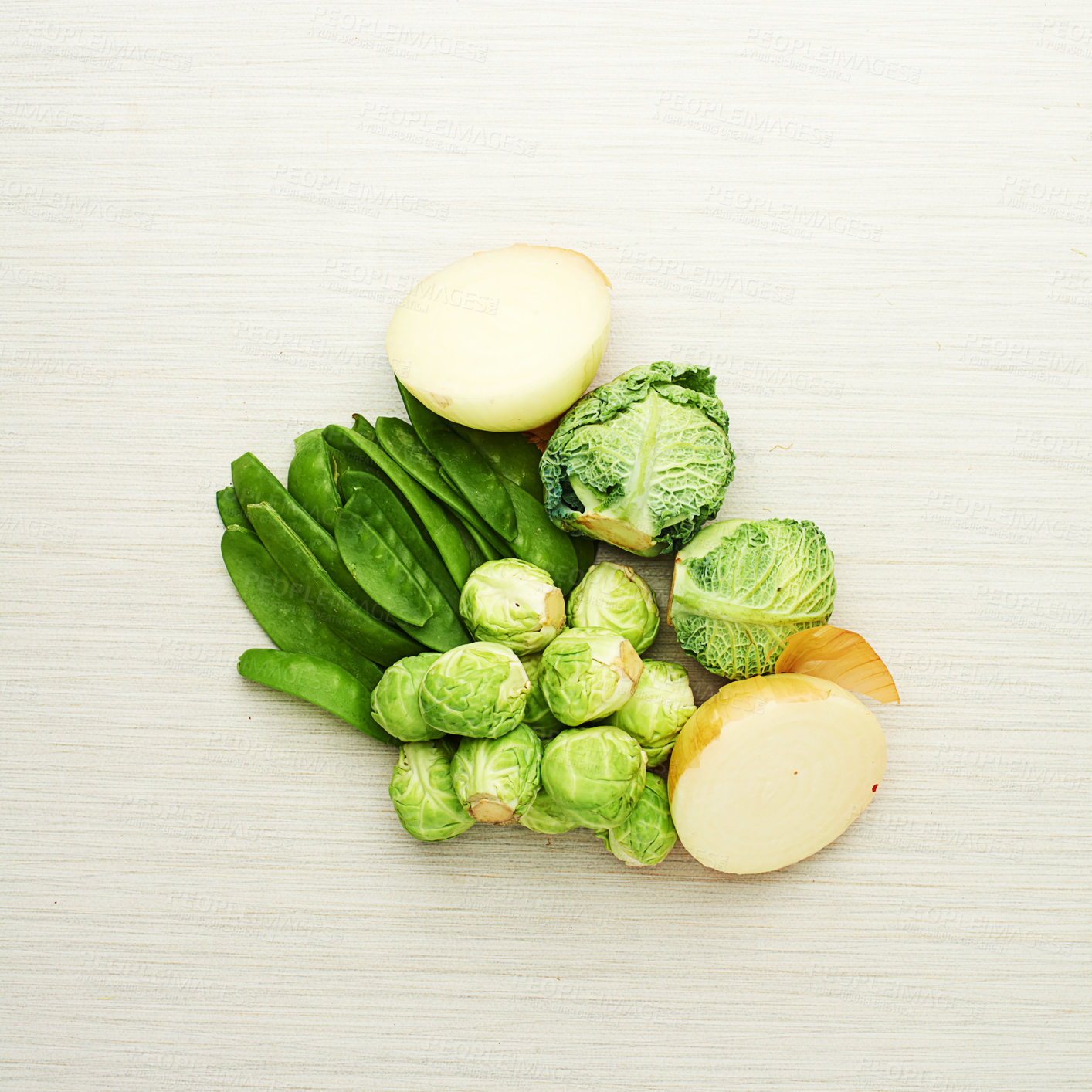Buy stock photo Healthy, vegetables and nutrition from ingredients on table for soup, recipe and meal prep in kitchen. Onion, cabbage and brussels with peas for dinner, food and green diet for wellness in home