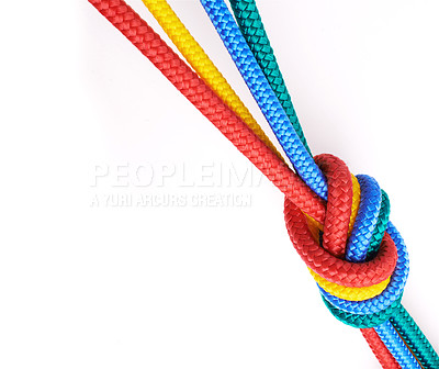 Buy stock photo Colourful rainbow ropes in an overhand knot, tied together isolated against a white studio background. Connected group of many different ropes together. Community, trust, faith. Metaphor for learning