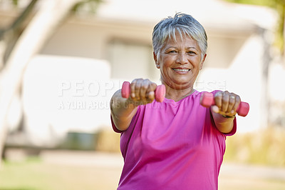 Buy stock photo Portrait of a mature woman lifting dumbbells outside