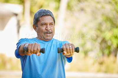 Buy stock photo Cropped shot of a mature man lifting dumbbells outside