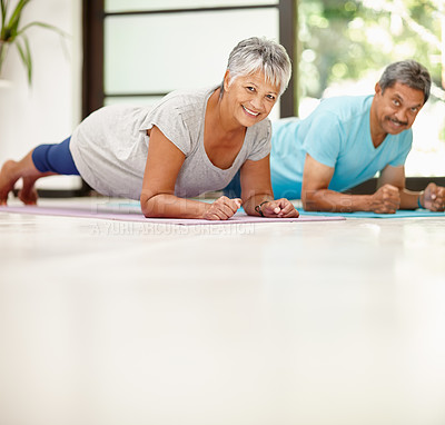 Buy stock photo Portrait of a mature couple exercising together at home