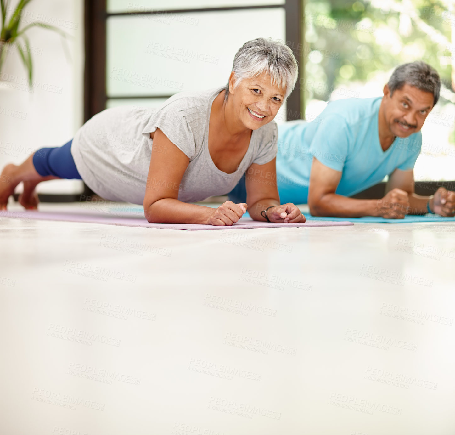 Buy stock photo Portrait of a mature couple exercising together at home