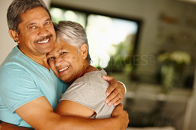 Buy stock photo Portrait of a mature couple embracing at home